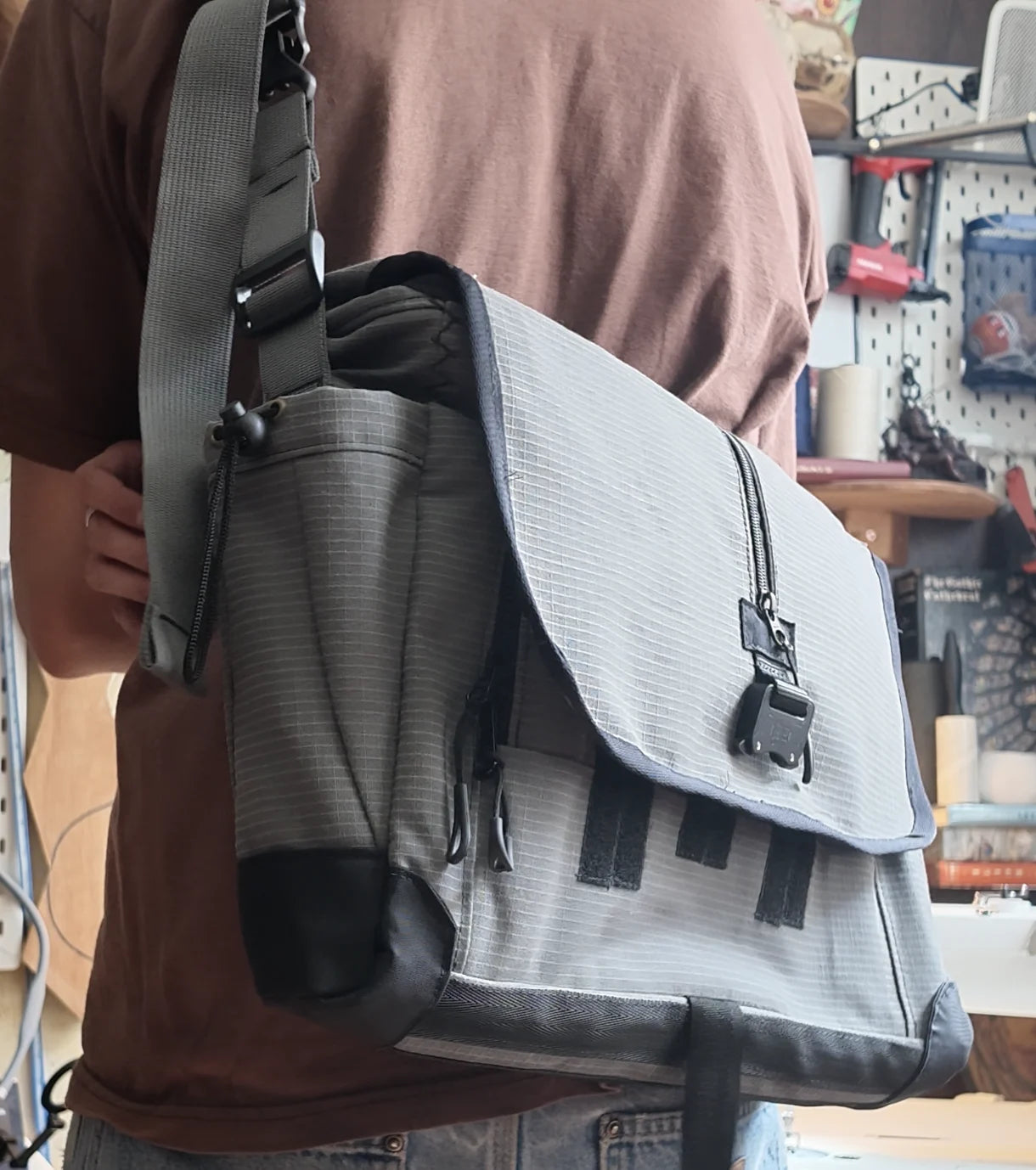 Courier Bag worn cross-body, showing its side pocket and reinforced corners